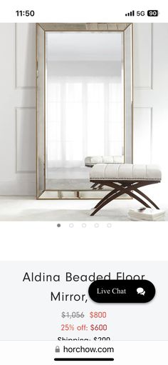 a mirror sitting on top of a white floor next to a bench and window sill