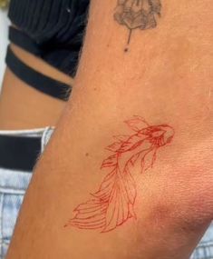 a woman's arm with a tattoo on it and a flower in the center