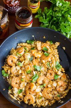 shrimp and rice in a skillet with cilantro, parsley and mustard