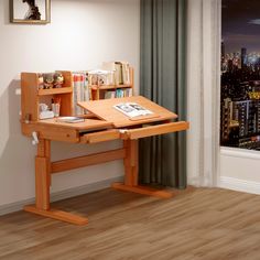 a wooden desk with books on it in front of a cityscape and window