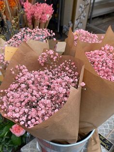 some pink flowers are sitting in a bucket