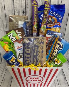 a popcorn bucket filled with snacks and candy