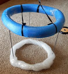 a blue and white object sitting on top of a carpet