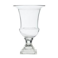 a clear glass vase sitting on top of a wooden stand with an empty bowl in the middle