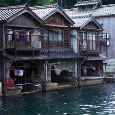 an old wooden house with clothes hanging out to dry on the porchs and balconies