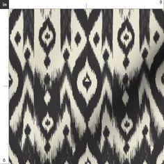 a black and white fabric with an abstract design on it's back side, showing the