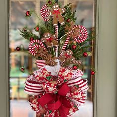 Gingerbread Christmas tree topper with Gingerbread men, gingerbread snowflakes, red bells, curlicues, white poinsettia and a coordinating designer bow will be the crowning achievement to your holiday tree! This topper is 45" from top ornament to the tip of the ribbons.  The bow is made from 4 different ribbons all in colors that coordinate with the top.  The bow is 14 inches wide and has eight ribbon streamers ranging from 18 inches length to 24 inches length. This handmade tree topper will be t Gingerbread Snowflakes, Ribbon Streamers, White Poinsettia, Gingerbread Christmas Tree, Christmas Tree Topper Bow, Handmade Tree, Ornaments Tree, Tree Topper Bow, Gingerbread Christmas