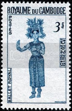 an old stamp with a woman wearing a headdress and holding a flower in her hand