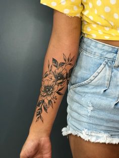 a woman's arm with a flower tattoo on the left side of her body