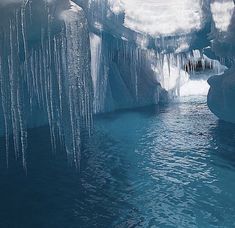 an ice cave with icicles hanging from the ceiling and water running down it's sides