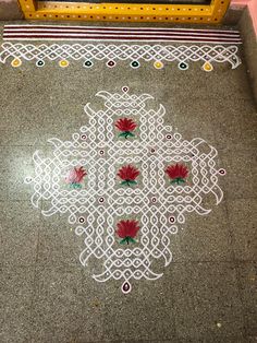 the floor is decorated with white and red flowers, which are surrounded by intricately designed designs