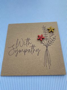 a card with two flowers and the words sympathy written on it