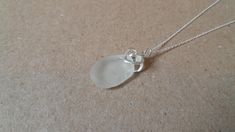 Here is a lovely piece of pure white seaglass from County Donegal - Ireland.  Extremely smooth and good quality - a fabulous oval shape. Mounted on a sterling silver 16mm delicate chain from a gorgeous little sterling silver bail. Presented on a simple recycled card with our 'Donegal Seagass' logo sticker.  The glass is not treated or altered apart from having a small hole drilled through it for attaching the bail. A genuine and stylish authentic gift from Ireland. Wear a little piece of Ireland County Donegal, Donegal Ireland, Delicate Chain, Stunning Necklace, Logo Sticker, Gorgeous Earrings, Just Amazing, Pure White, Sea Glass