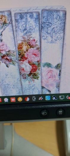 a computer screen with four images of flowers on it's back side and an image of roses in the background