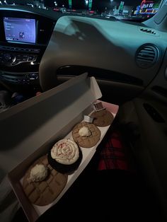 an open car trunk filled with assorted desserts