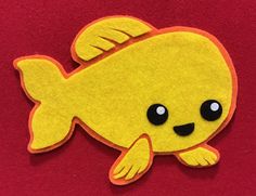 a yellow fish with black eyes on a red background