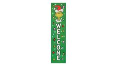 a green welcome sign with a santa hat on it's head and the words welcome