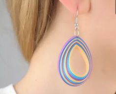 a close up of a pair of earrings on a woman's ear