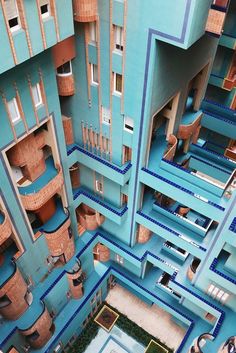 an aerial view of the inside of a building with blue walls and balconies