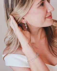 One of our most popular styles, our Sydney Floral CZ Earrings are handcrafted with CZ stones in a floral design. Artfully designed, you'll want to wear these earrings long after your wedding day. Cubic zirconias. Measures 1.25" long Available in pierced or clip version Matching bracelet available Hypoallergenic, lead-free & nickel-free Style #4140 Photo Credit: Han Designed & Hunter Hennes Photography Hand Set Cubic Zirconia Earrings, Diamond White Diamond Flower Earrings For Wedding, Elegant Flower Earrings With Sparkling Stones For Wedding, Elegant Wedding Flower Earrings With Sparkling Stones, Wedding Fine Jewelry Chandelier Drop Earrings, Dazzling Hand Set Diamond Wedding Earrings, Dazzling Hand Set Diamond Earrings For Wedding, Dazzling Hand-set Diamond Wedding Earrings, Dazzling Hand-set Diamond Earrings For Wedding