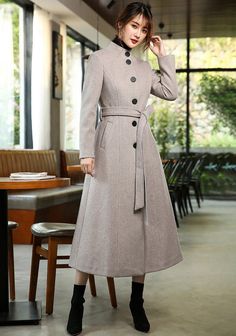 Elevate your winter wardrobe with our Stand Collar Single Breasted Flared Wool Blend Long Coat. Made from a luxurious wool blend, this single breasted coat features a stand collar and belted waist for a chic and flattering fit. The fit & flare style adds a touch of sophistication, making this long coat a must-have for any fashion-forward woman. Stay warm and stylish all season long! ●Single-breasted button closure●Stand collar ●Lined ●Front welt pockets ●Removable tie belt ●50% wool and polyeste Long Belted Wool Coat For Fall, Fitted Long Wool Coat In Solid Color, Long Single-breasted Wool Coat For Office, Elegant Long Wool Coat For Spring, Fitted Belted Wool Coat For Winter, Beige Wool Coat With Stand Collar For Winter, Winter Long Belted Wool Coat, Winter Wool Long Coat With Belt, Elegant Wool Coat With Stand Collar And Buttons