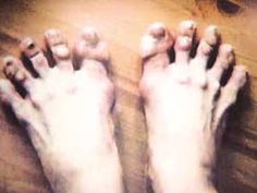 a person's bare feet on a wooden floor