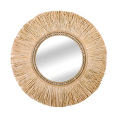 a round mirror that is made out of straw and has fringes on the edge