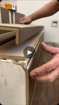 a person is working on a piece of furniture with their hands and thumbnails