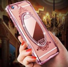 a woman's hand holding an iphone case with a mirror on it