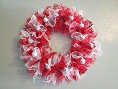 a red and white wreath hanging on the wall