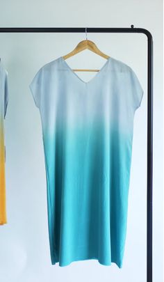 Hand dyed v-neck silk dress. Silver gray gradually transitioning to teal or aqua blue.Knee length dress which can be worn as an airy tunic.This is made to order dress, please allow 2 weeks for fabrication.Minimal sack dress with slight A-line silhouette.Made with medium weight crepe de chine silk.Hand made and hand dyed one at a time.Easy care, it can be hand hand washed or dry cleaned.Each one is unique.When ordering, please provide me with your dress size in number.  If you want the dress tail Blue Knee Length Dress, Gradient Dress, Grey Silk Dress, Sack Dress, Tail Dress, Ombre Dress, Dress Silver, Hand Dyed Fabric, Dyed Silk