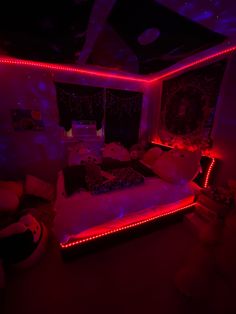 a bed with red lights on it in a room filled with furniture and decor items