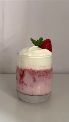 a dessert in a glass with strawberries on top