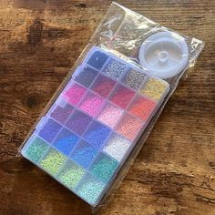 a pack of beads sitting on top of a wooden table