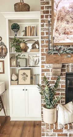 a living room filled with furniture and a fire place in front of a brick wall