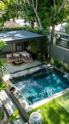 an outdoor swimming pool surrounded by greenery