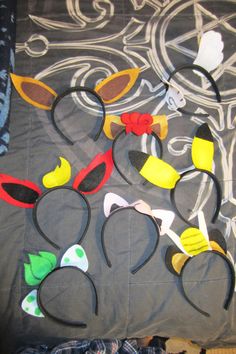 several mickey mouse ears are laid out on a quilt