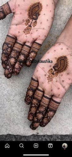 two hands with henna tattoos on them