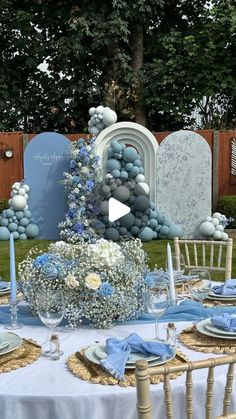 a table is set with blue and white decorations