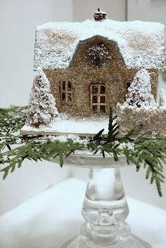 there is a cake that has been made to look like a house with snow on it