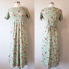 Beautiful vintage dress with pockets. Green with fuchsia and gold flowers, ties in back and has a slight empire waist. No tag on the dress but it fits like a medium and feels like a cotton spandex blend. Please read over the dress measurements carefully, to make sure the fit is okay for you, as I'm unable to accept returns/exchanges at the moment. Measurements are taken while garment is laid flat so please double the pit to pit and waist measurement.  ~Dress Measurements~  Pit to pit: 19 inches Waist: 18 inches Length: 48 inches  For reference, mannequin measurements are: Size 6/8 Bust 36.5" Waist 25" Modest Green Flowy Maxi Dress, Fitted Modest Maxi Dress With Modesty Panel, Modest Fitted Floral Maxi Dress, Modest Flowy Floral Midi Dress, Modest A-line Dress With Floral Print, Modest Fitted Floral Dress For Garden Party, Modest Maxi Dress With Pockets, Green Maxi Dress With Pockets, Green Spring Midi Dress With Pockets