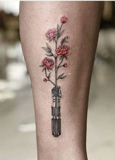 25 Star Wars Tattoo Ideas That You Will Absolutely Adore Starwars Tattoo Girly, Flower Lightsaber Tattoo, Star Wars Tattoo Flowers, Lightsaber With Flowers Tattoo, Nerd Tattoos For Women, Lightsaber Flower Tattoo, Star Wars Tattoo Aesthetic