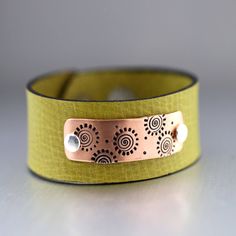 "Copper Spiral Leather Cuff Bracelet, Pea Green Cuff, Copper Bracelet, Copper Cuff, Mixed Metal Cuff, Adjustable Bracelet, Mod Leather Cuff Fun & NEW This mod LittleGreenRoom cuff bracelet is super cute and unique! Looking for the perfect gift that is one of a kind? This is your cuff... Hand stamped and given lots of LGR style and design!! This unique copper plaque has been riveted to a gorgeous pea green leather adjustable strap that is 1\" wide and adjusts from 6 3/4\"-8 1/4\" with two nic Sunflower Earrings, Leather Cuff Bracelet, Copper Cuff, Leather Cuffs Bracelet, Copper Bracelet, Leather Cuffs, Antique Dolls, Green Leather, Leather Jewelry