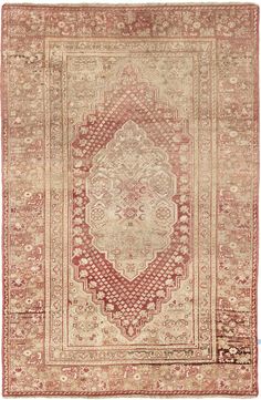 an antique rug with red and beige colors