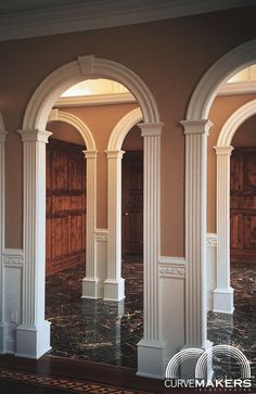 an empty room with columns and marble flooring