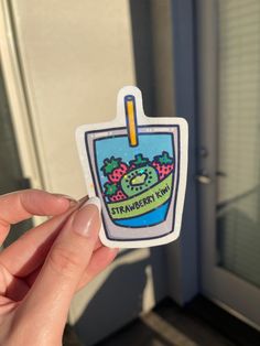 someone is holding up a sticker with an image of a strawberries kabob on it