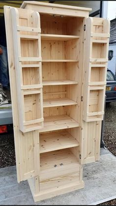 a large wooden cabinet sitting on top of a cement slab