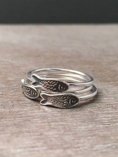 This listing is for ONE fish stack ring, not three. This delicate sterling silver fish ring is made from a unique hand cut stamp. It is stamped onto very thick silver, and then I hand cut it out with a saw. The tiny shape that is created is then soldered onto a 16 gauge ring band. Each ring is made to order and can take 1-2 weeks to finish for you, so please plan accordingly. ***please note that the patina comes out slightly different every time I make these, it may come out lighter or darker, o Cool Rings Silver, Silver Jewelry Boho, Unique Sterling Silver Rings, Cool Silver Rings, Quirky Rings, Weird Rings, Hippie Wedding Ring, Silver Rings Aesthetic, Interesting Rings