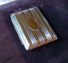 "Art Deco pocket case with two sides Pocket case holds business/credit cards, 14 king size cigarettes or what you will Round corners and edges give great hand held feel Crush proof Nickel plated German steel for years of continual use Secure clasp Struck from original German dies dating from the 1920's & 30's Fits neatly in pocket or purse Engravable inside and out German silver finish for years of use Measurements: 2 1/2\" x 3 5/8\" x 5/8\" (63.5mm x 92mm x 16mm) \"why not the best\" German qua Classic Silver Card Holder For Formal Occasions, Silver Classic Card Holder For Formal Occasions, Classic Silver Rectangular Card Holder, Classic Silver Card Holder With Card Slots, Gold Rectangular Card Holder For Formal Use, Gold Rectangular Formal Card Holder, Formal Gold Rectangular Card Holder, Business Credit, Business Credit Cards