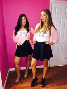 two young women standing next to each other in front of a pink wall wearing matching outfits